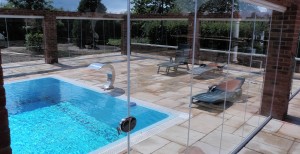 single glazed tempered glass doors forming retractable swimming pool enclosure