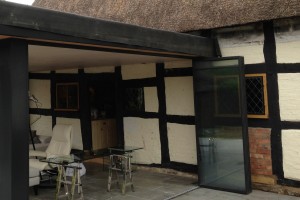 Thatched Hosue with sympathetic enclosure, UltraSlim slide-turn-stack doors