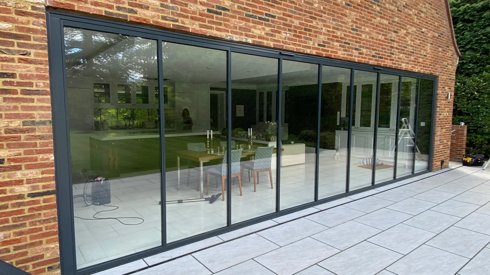 Ultra slim bifold doors between an open plan kitchen and patio in a modern brick home in the UK