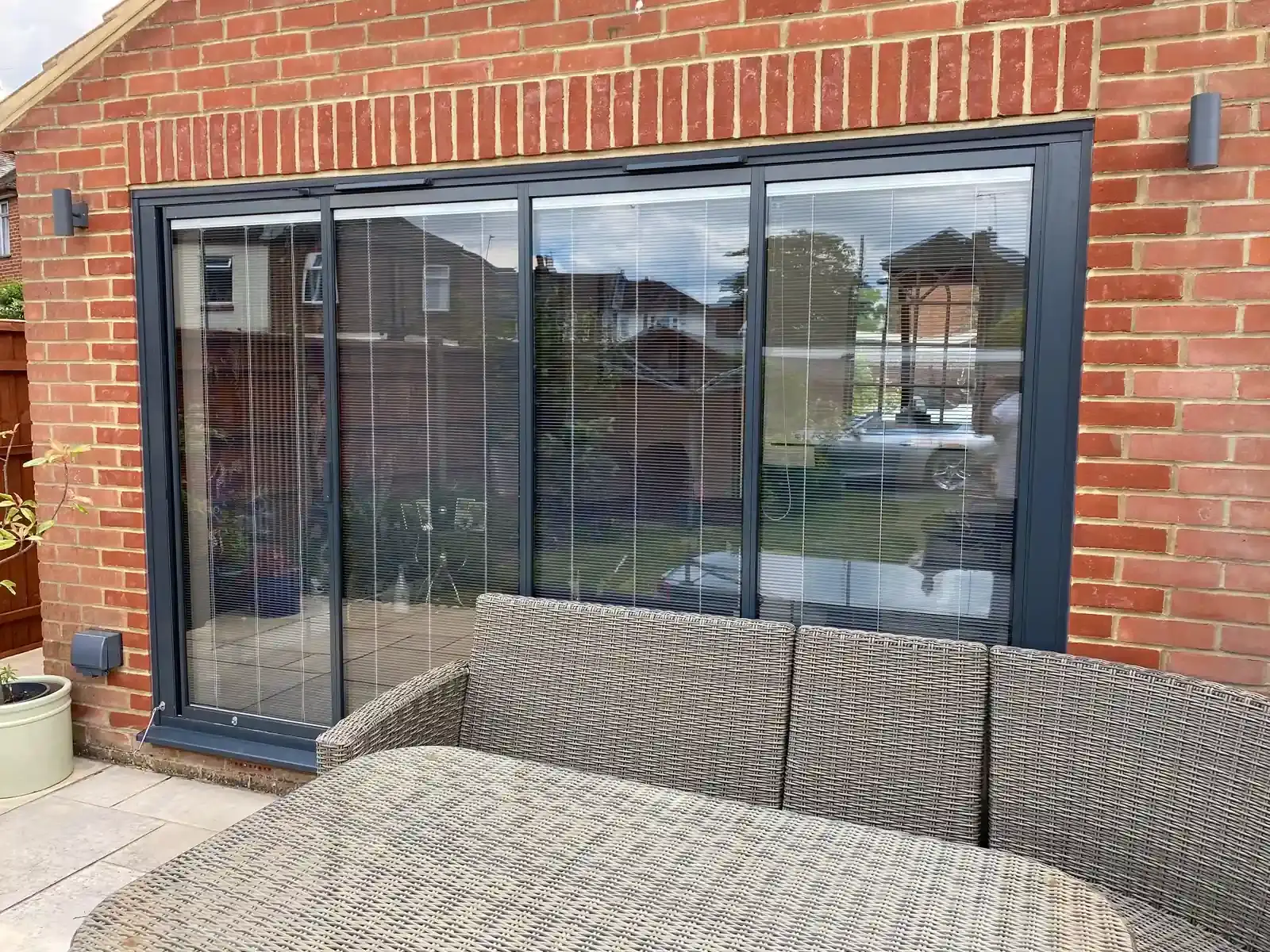 grey aluminium bifold doors with integral blinds